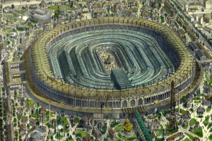 Luftaufnahme eines großen Stadions umgeben von Gebäuden, Bäumen und Gras in einer Stadt.