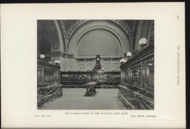 Schwarze und weiße Fotografie des Banketts der National Park Bank in New York City, mit Tischen, Lampen, einer Uhr an der Wand und Text unten.