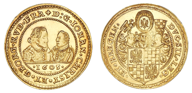 Goldmünze mit einem Wappen, Text und dekorativen Bildern auf einem weißen Hintergrund.